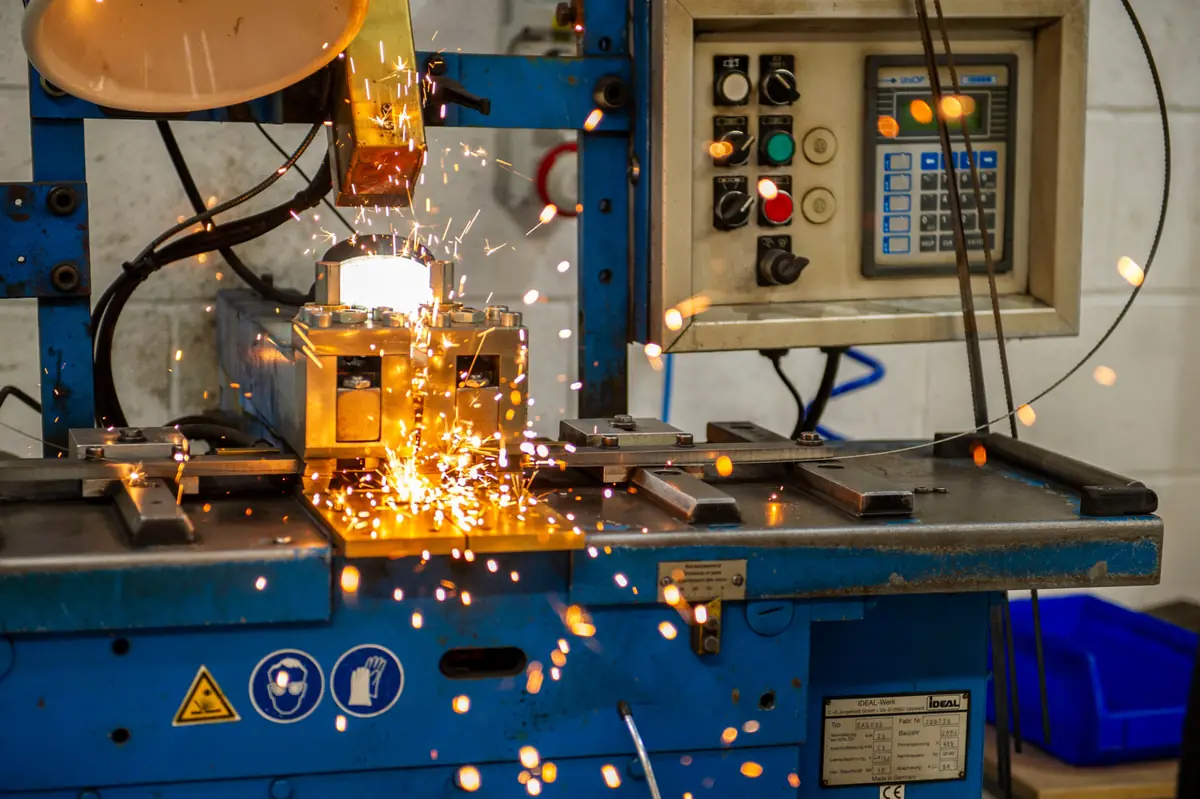 Bandsaw blade being welded to length, sparks flying, at the Nottingham Weld Centre